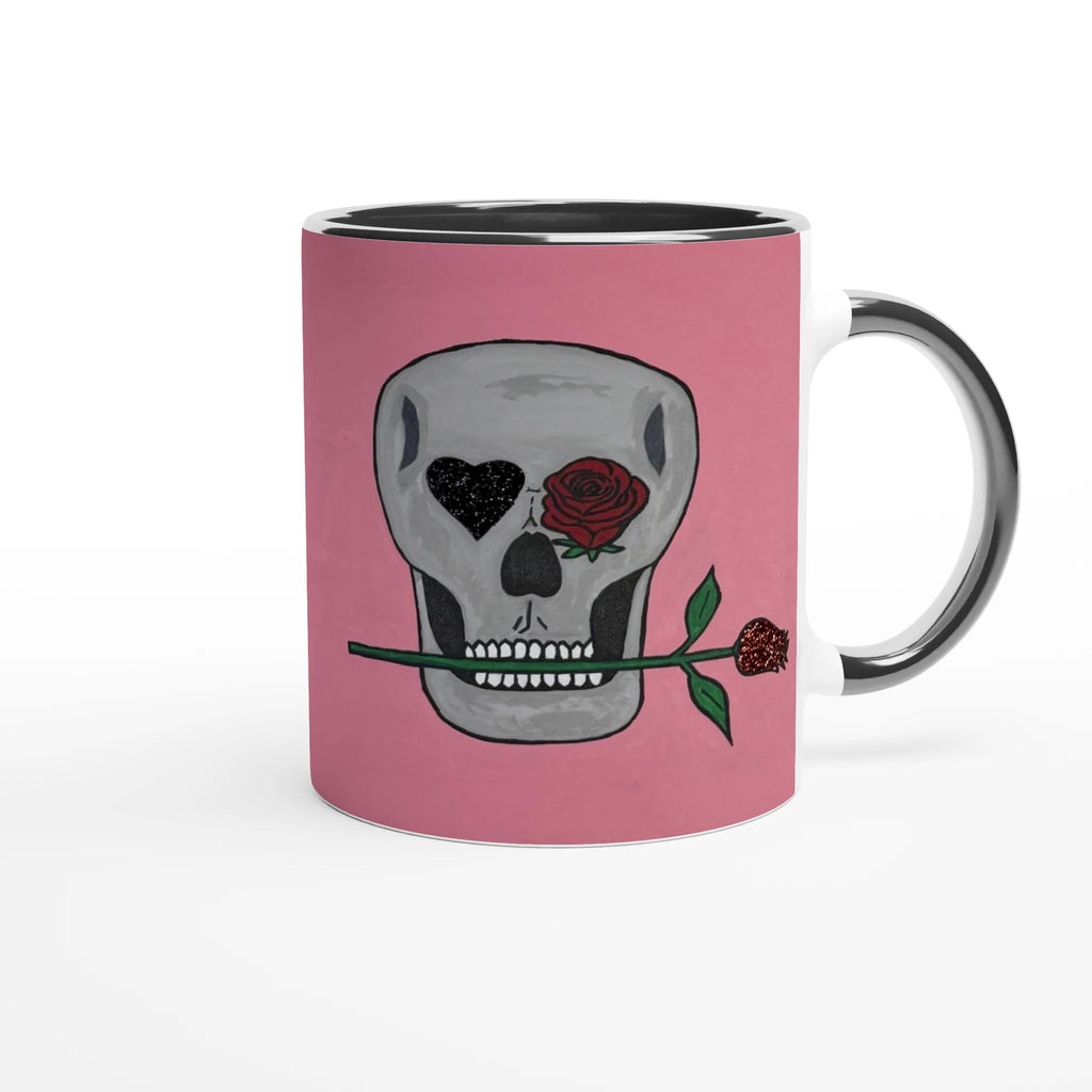 11 oz glossy ceramic mug showing Johnny X's Skull and Roses: gray skull on pink background with roses and a glittering heart eye