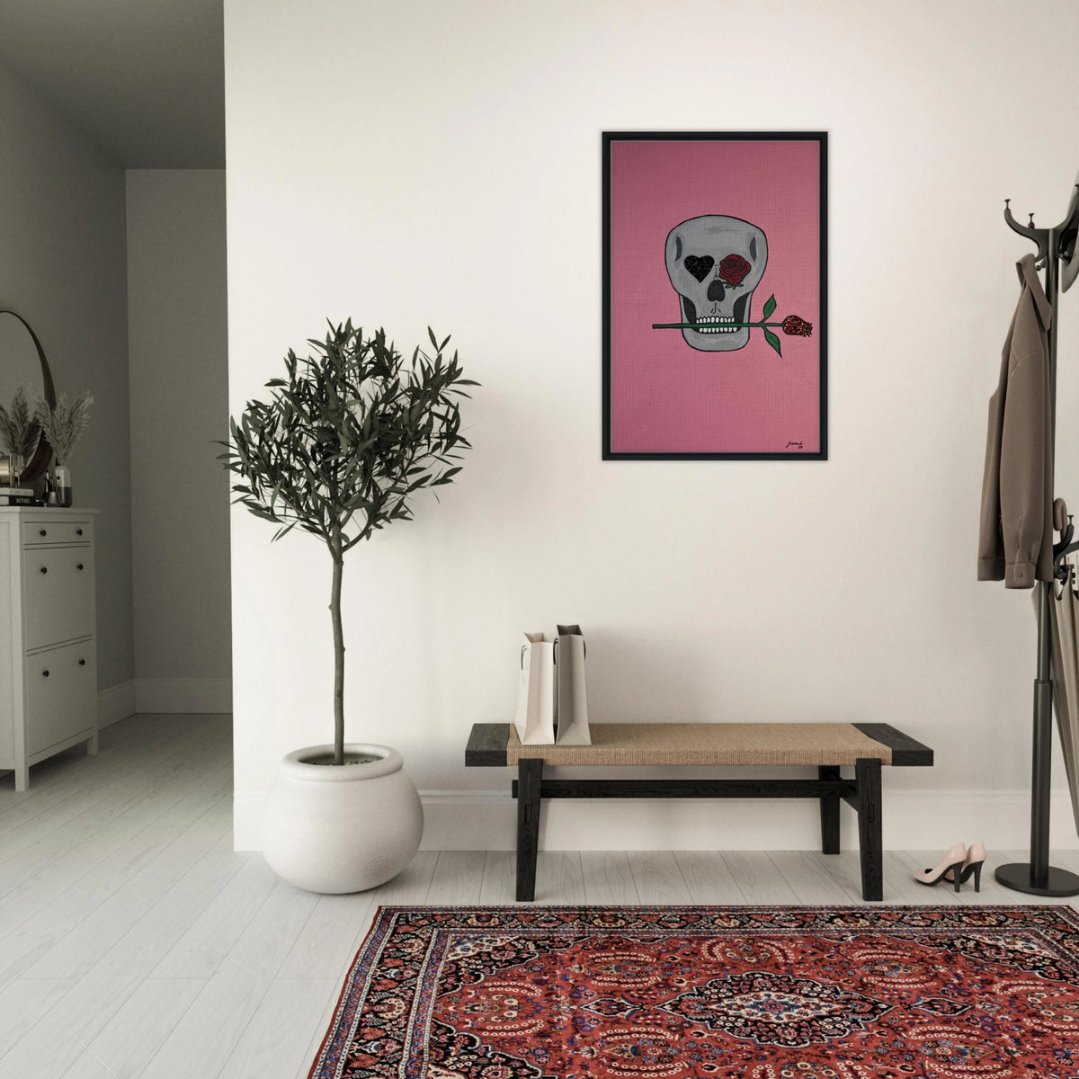 Framed 24×36 Johnny X canvas showing a gray skull on pink field, one eye a black heart, the other a red rose, a rose between its teeth.