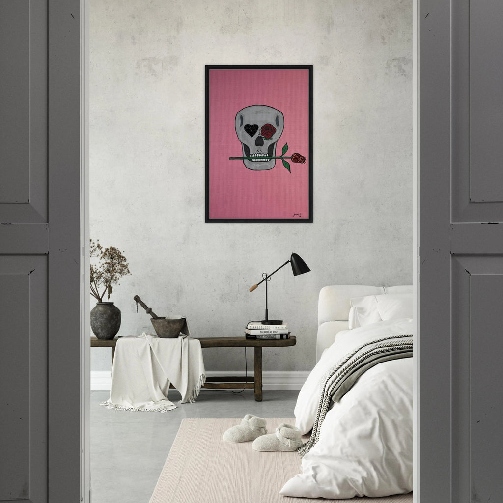 Framed 24×36 Johnny X canvas showing a gray skull on pink field, one eye a black heart, the other a red rose, a rose between its teeth.