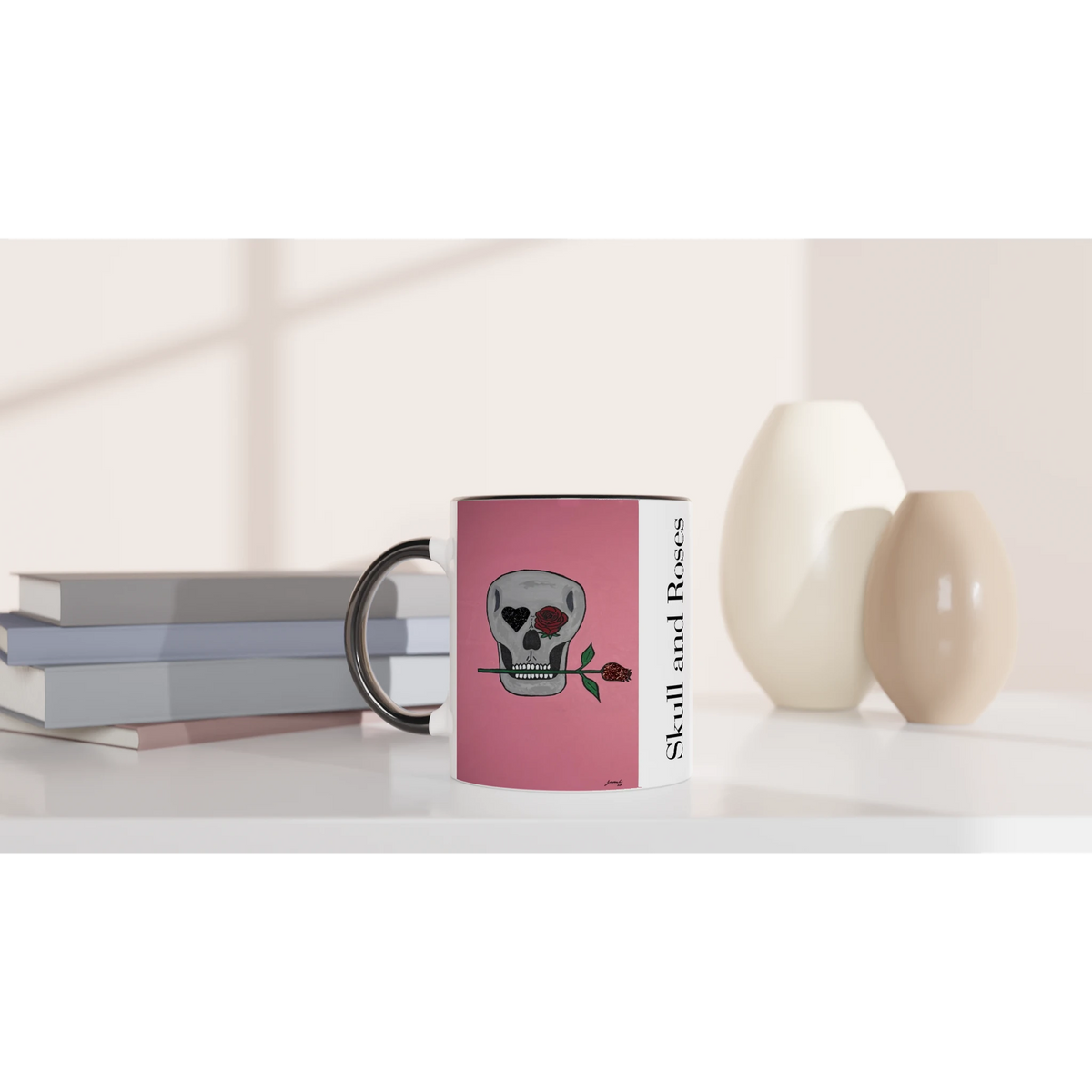 11 oz glossy ceramic mug showing Johnny X's Skull and Roses: gray skull on pink background with roses and a glittering heart eye