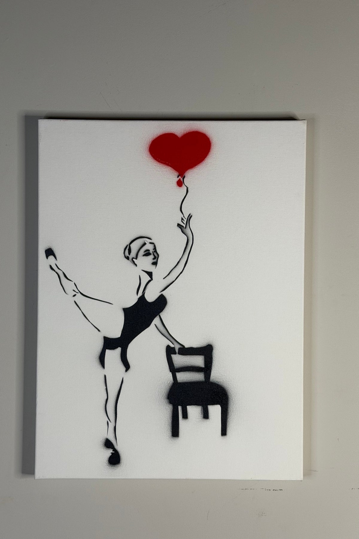Balloon of Love by Johnny X, an 18 × 24-inch contemporary artwork depicting a young ballerina balancing beside an empty black chair while reaching toward a floating red heart-shaped balloon, connected to her hand by a delicate string against a minimalist white background.