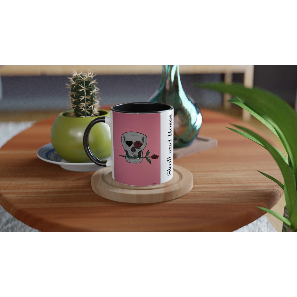 11 oz glossy ceramic mug showing Johnny X's Skull and Roses: gray skull on pink background with roses and a glittering heart eye