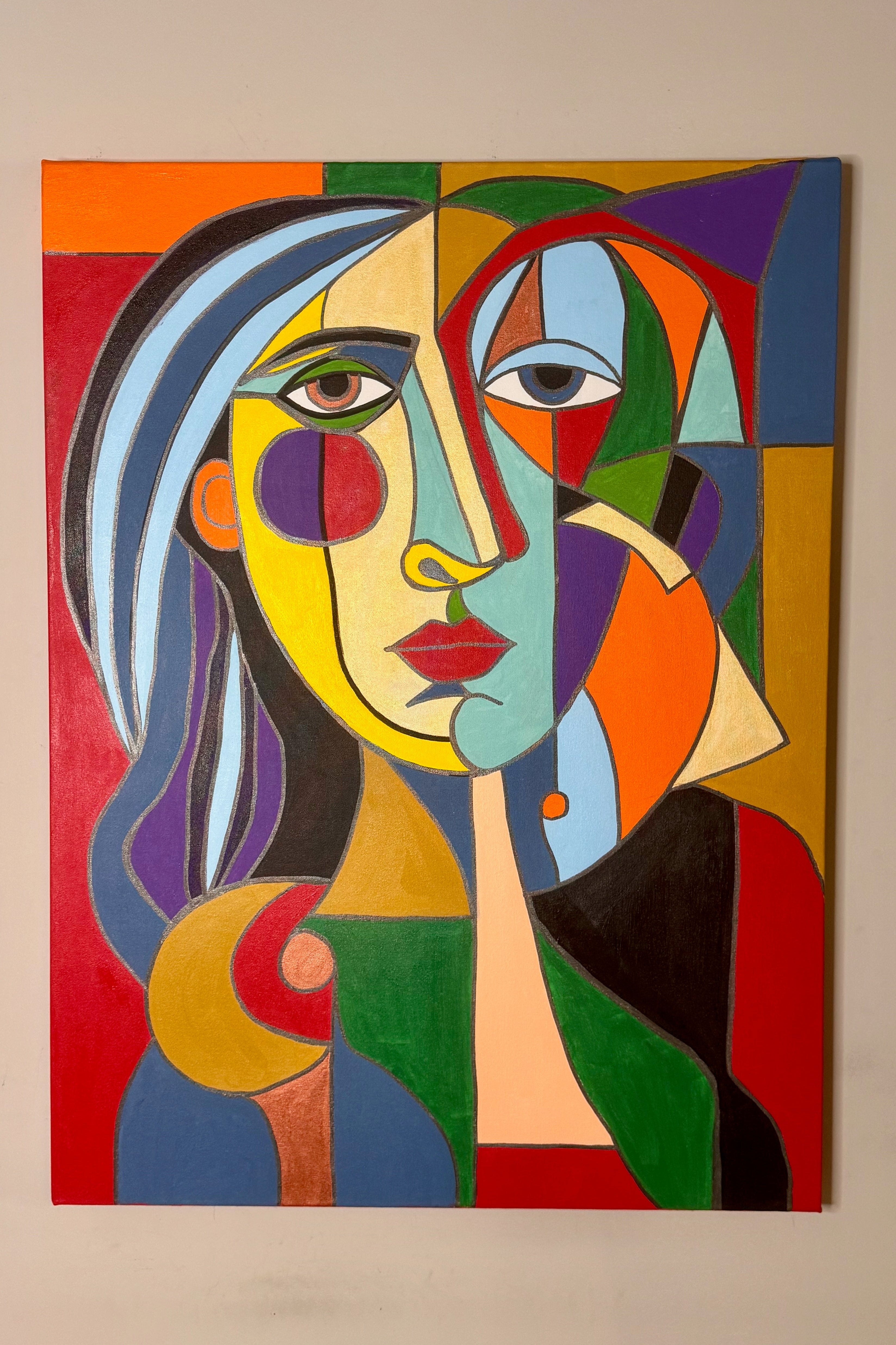 You’re Beautiful by Johnny X, a 30 × 40-inch contemporary portrait of a woman rendered in bold fragmented geometric forms, with vivid red, blue, green, gold, violet, orange, and black creating an expressive composition around her face and figure.